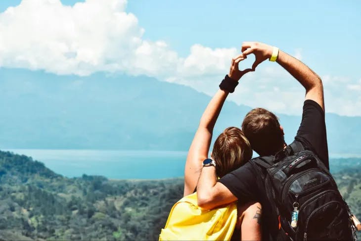 A couple making a heart shape with their hands