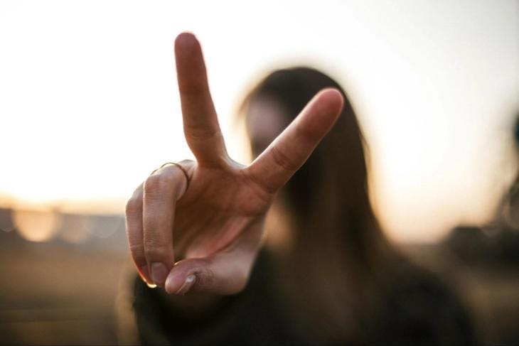 A girl showing a peace sign