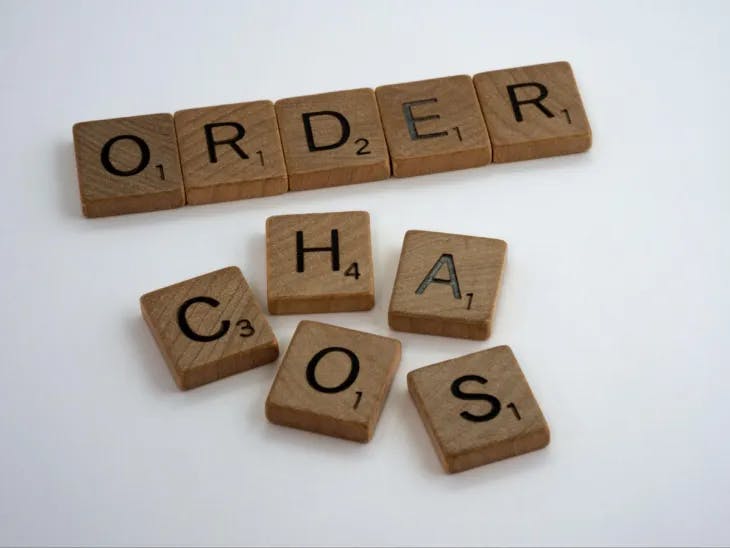 order and chaos spelled out with scrabble tiles 