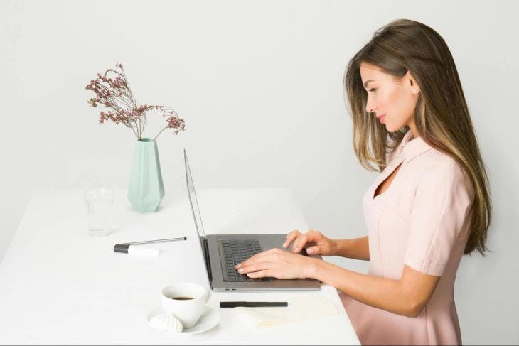 An enneagram 1 female working on a laptop