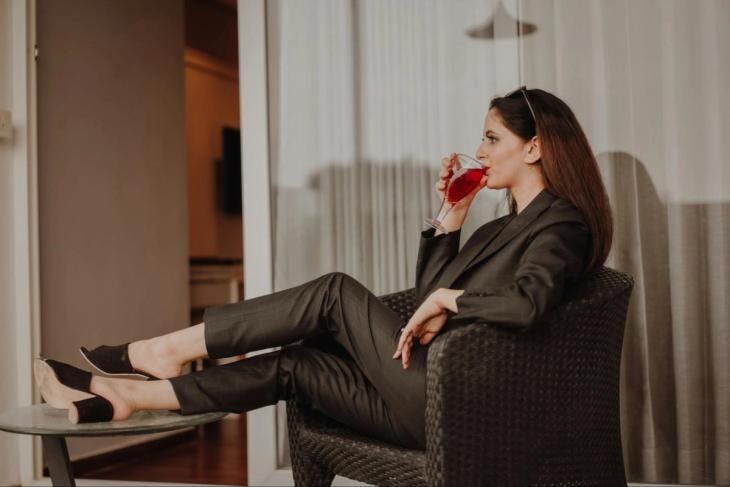 A woman drinking a glass of wine