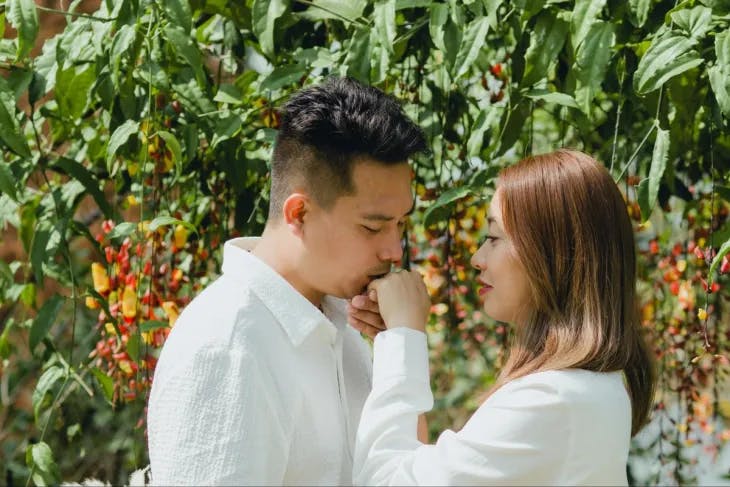 A man kissing a woman's hand