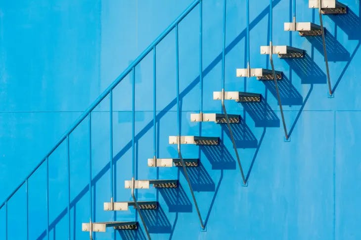 Staircase beside a blue wall