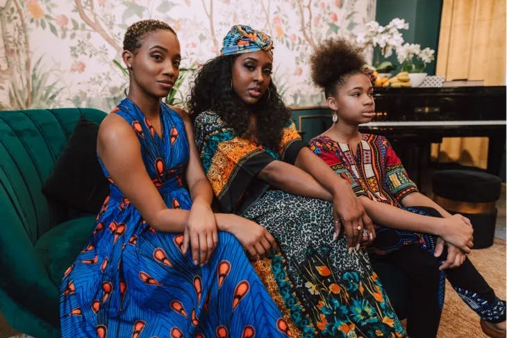 Three women in fashionable clothes 