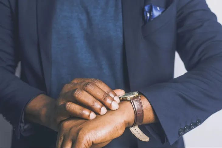 A man looking at his watch - enneagram orientation to time