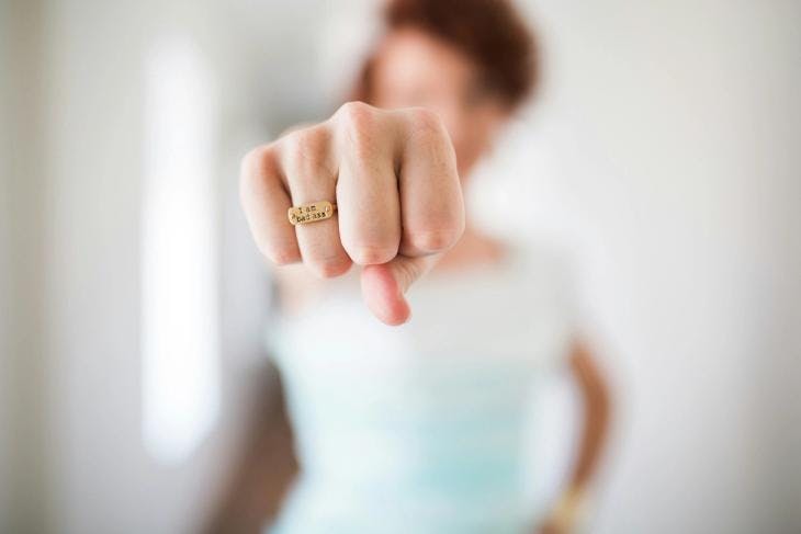 A confident woman extending her fist