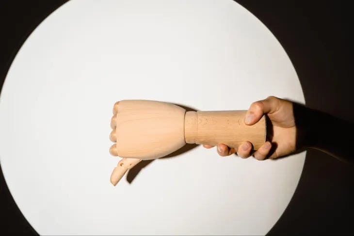 Wooden hand gesturing thumbs down